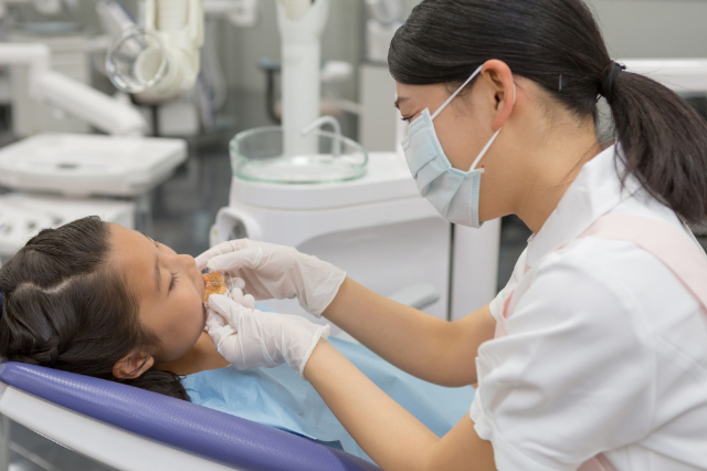 歯科医院で歯の矯正を始めた女の子